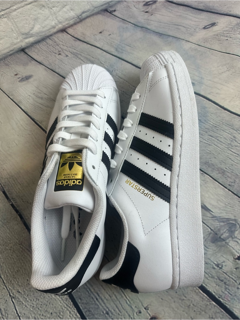 adidas Women’s White & Black Superstar Sneakers with Gold Logo